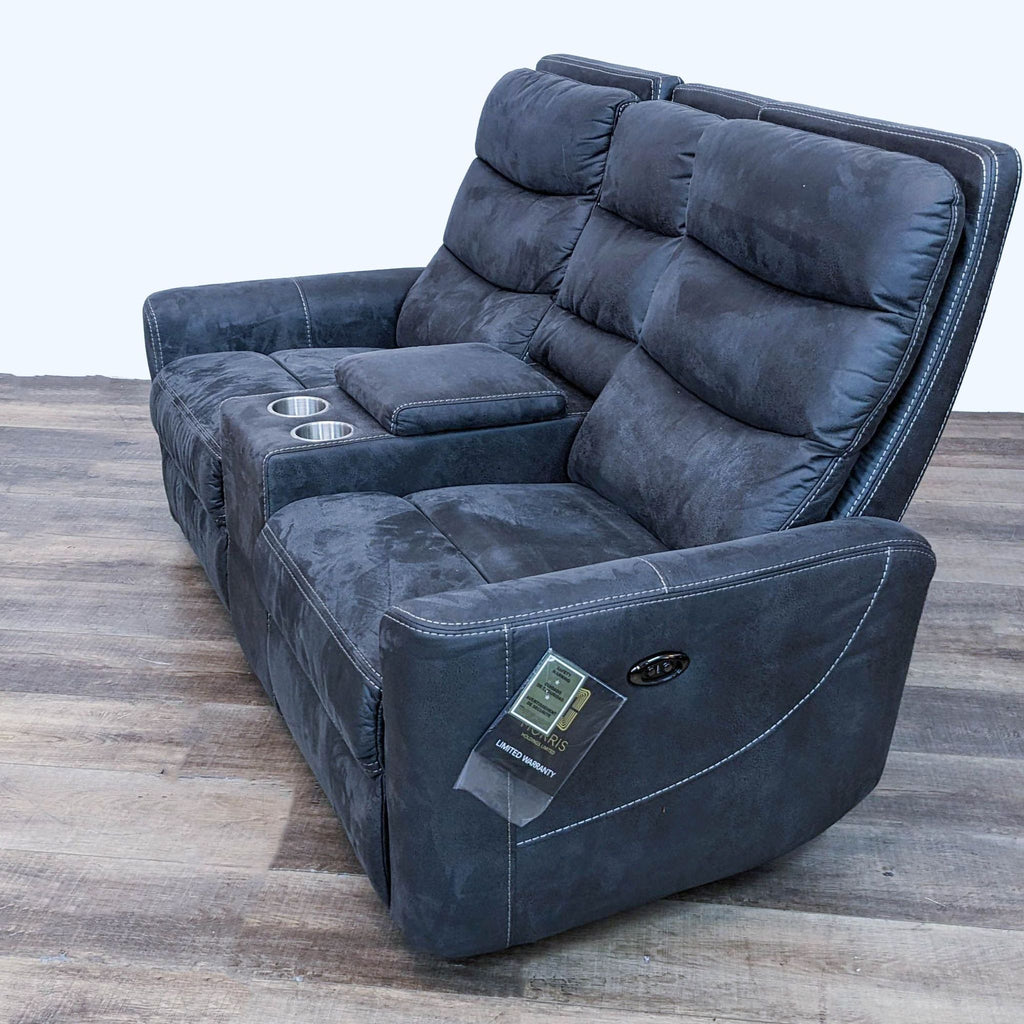 2. Side angle of the Malia power reclining loveseat by Living Spaces, showcasing built-in power and USB outlets, along with its plush armrest.