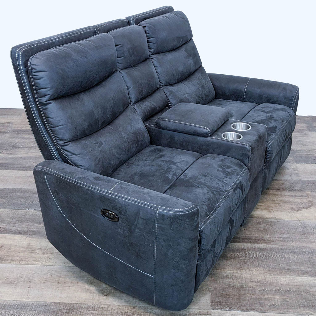 3. The Malia power reclining loveseat displayed at an angle, highlighting its extended footrest, storage console with cup holders, and sleek design.