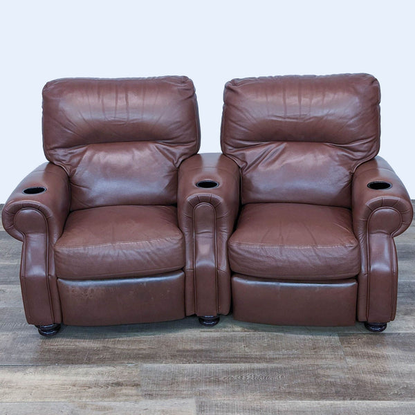 a pair of brown leather recliners