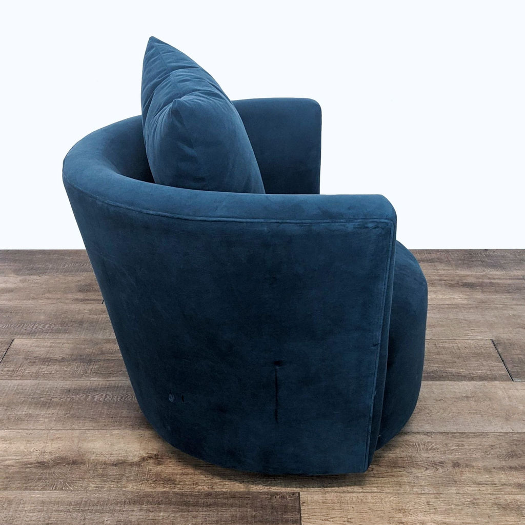 Blue Reperch microfiber lounge chair showcasing the swivel base and side profile.