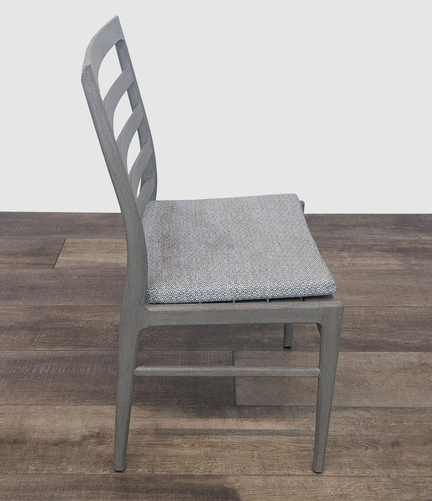 Side view of Reperch grey wood dining chair with textured removable seat cushion.  