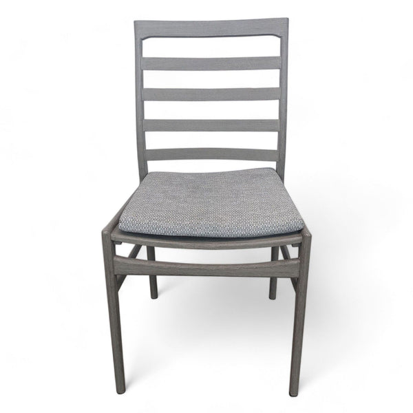 Reperch modern weathered ladderback chair with grey cushion, isolated on white.  