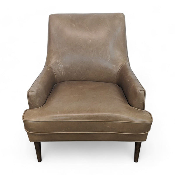 1. Frontal view of a Danya chair by Four Hands upholstered in camel-colored top-grain leather with tapered parawood legs.