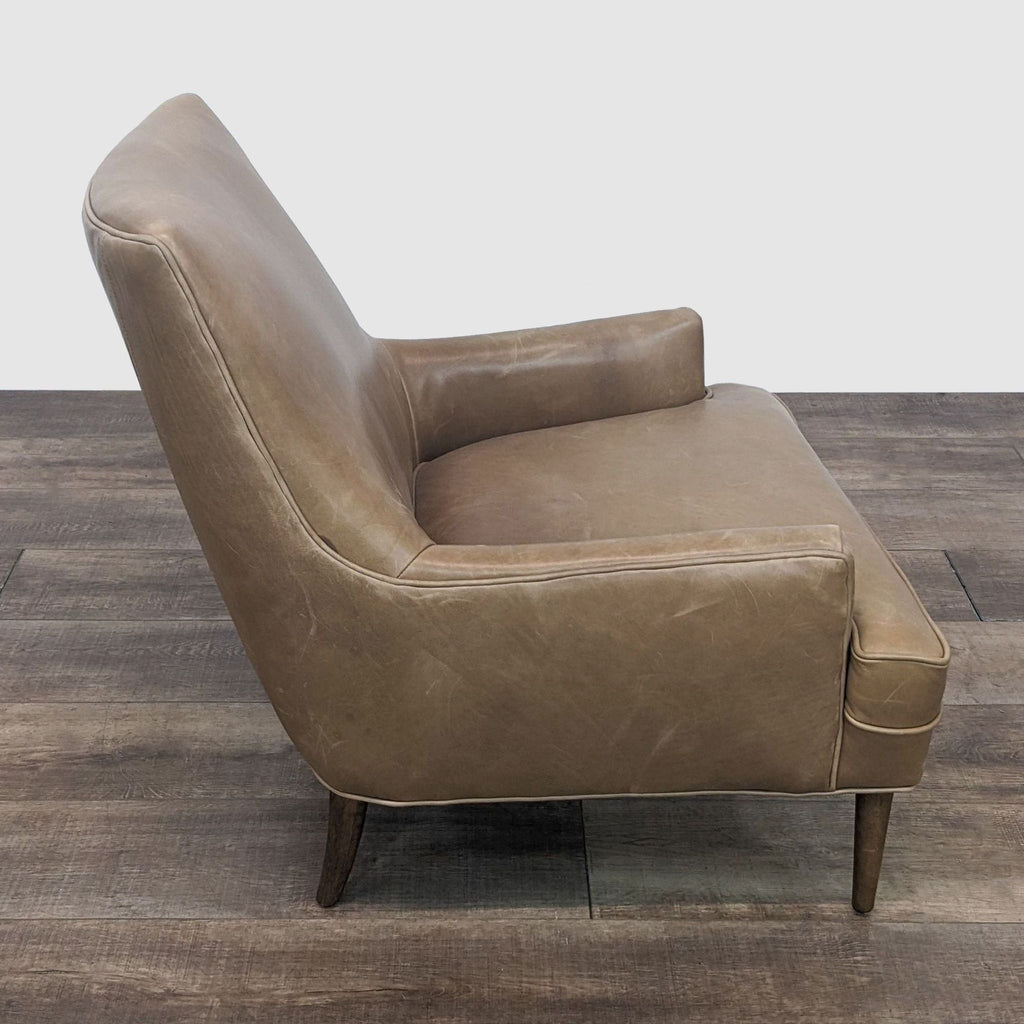2. Side perspective of a mid-century style Danya lounge chair featuring molded curves and warm leather upholstery.