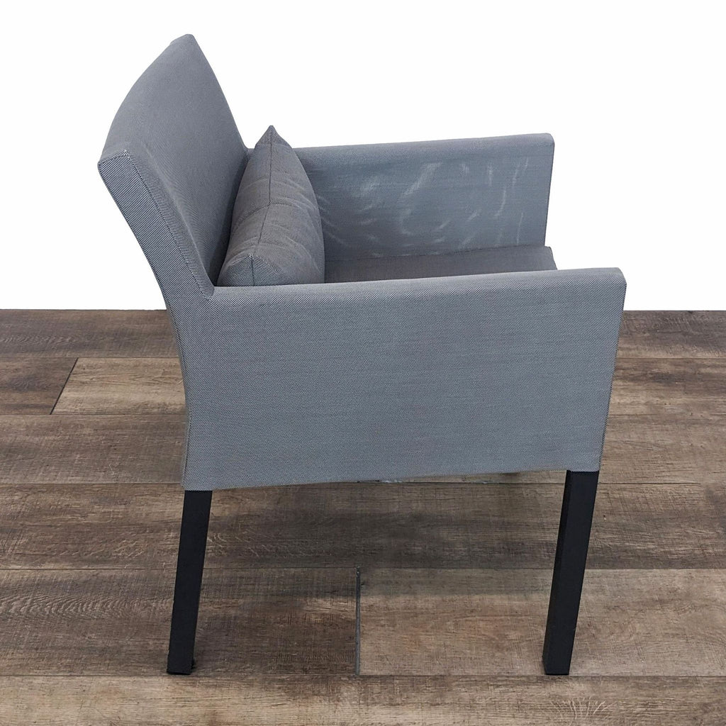 Side angle of a Ventana outdoor dining chair in grey with clean lines and a cushion.