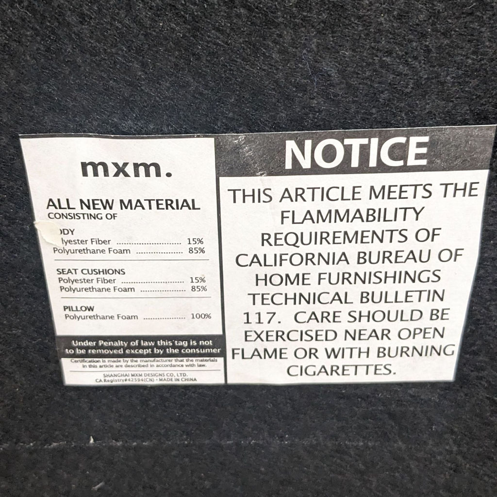 3. Close-up of the warning and materials label attached to a modern Reperch lounge chair, detailing flammability standards and composition.