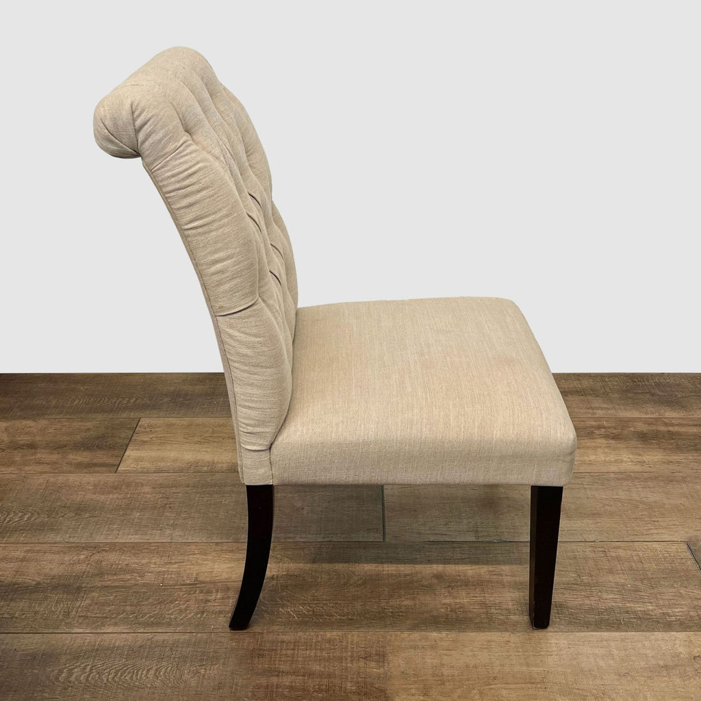 Alt text 2: Side view of a Cost Plus beige upholstered dining chair showing the curved button-tufted backrest and tapered legs.