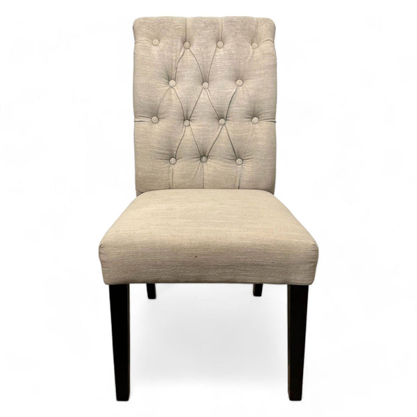 Alt text 1: Classic style beige dining chair with button tufting and dark tapered wood legs by Cost Plus.