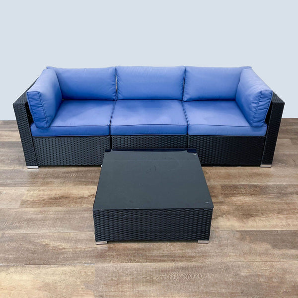 Reperch three-piece rattan outdoor set with blue cushions and a coffee table.