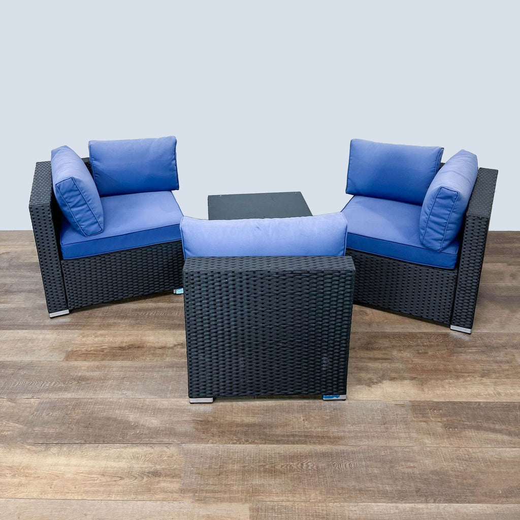 Three-piece outdoor sofa set by Reperch, with a rattan build, blue cushions, and chrome feet.