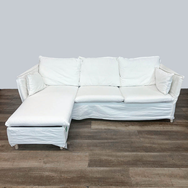 1. White Ikea sectional sofa with a chaise on the left, displayed in a room with wooden flooring.