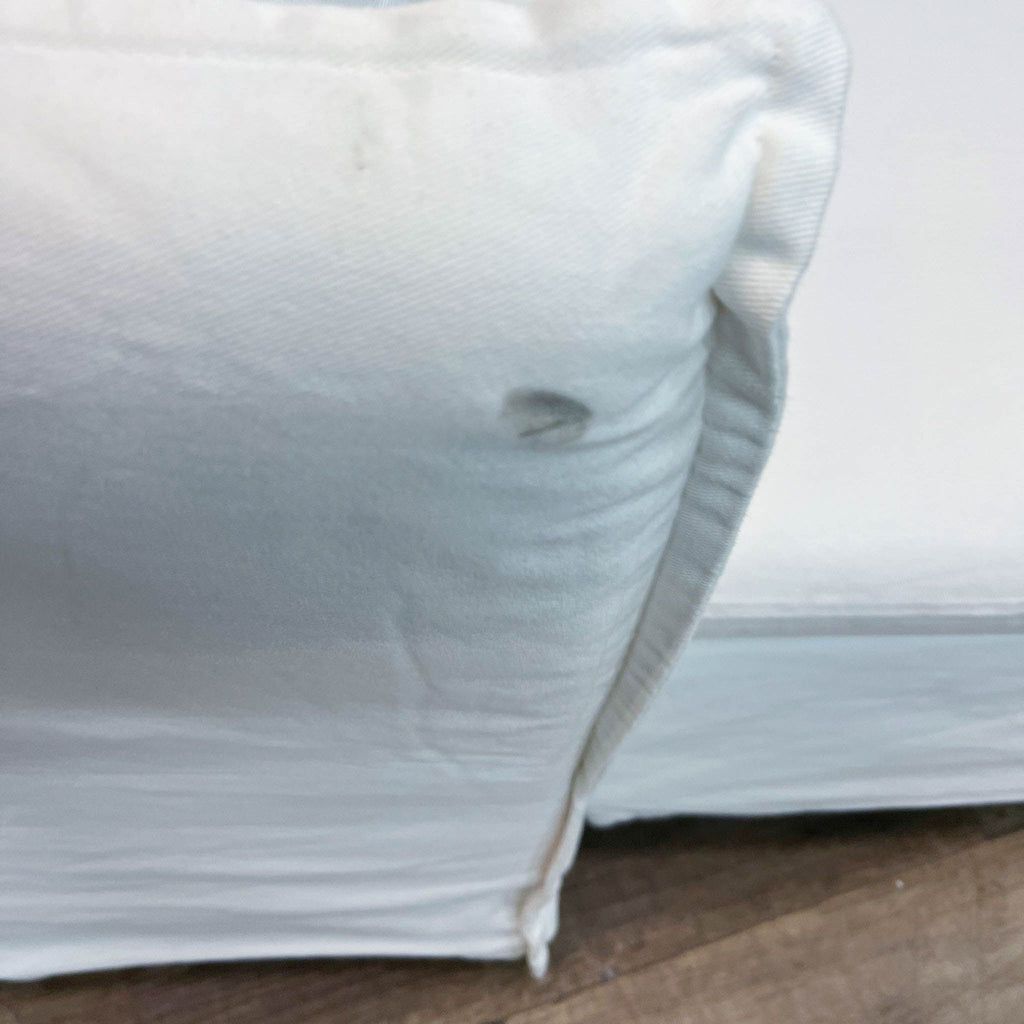 3. Close-up of an Ikea sectional corner showing fabric texture details and stitching on a white slipcover.