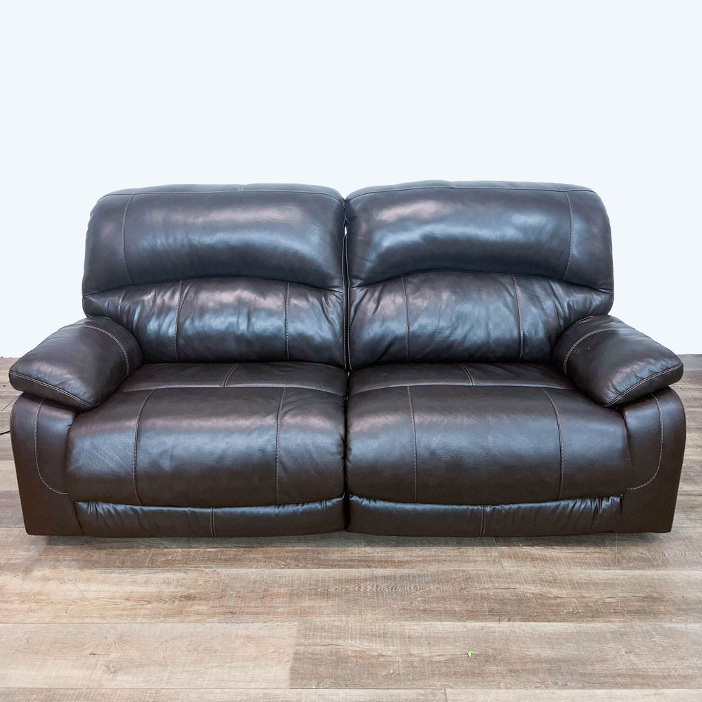 Ashley Hallstrung loveseat in faux leather with a closed power recliner and headrest.
