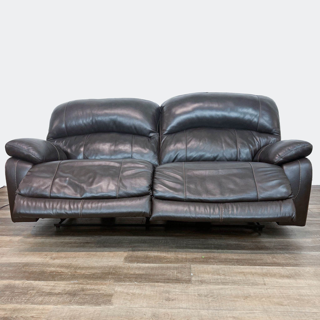 Ashley branded Hallstrung faux leather loveseat with partially extended recliners.