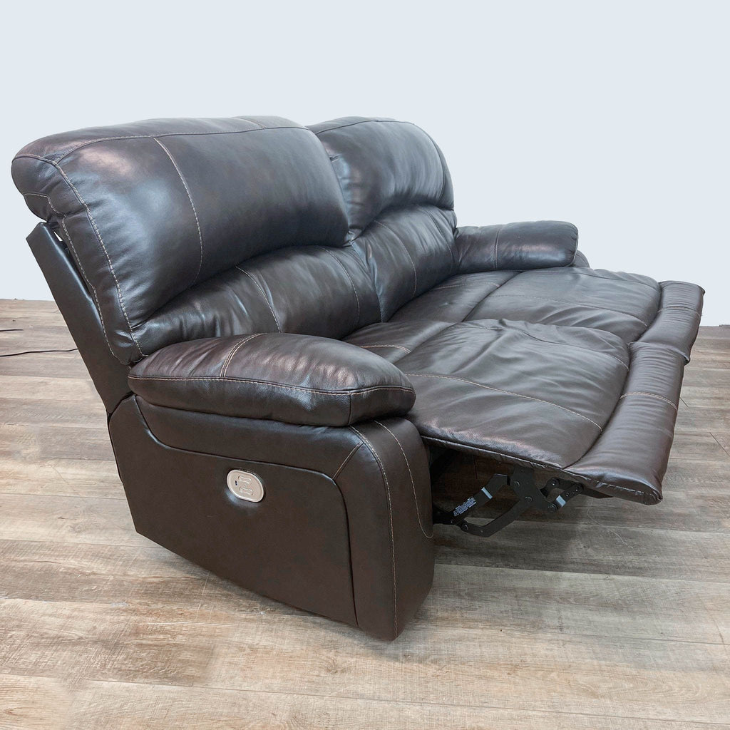 Ashley Hallstrung loveseat featuring fully extended power recliner and raised headrest.