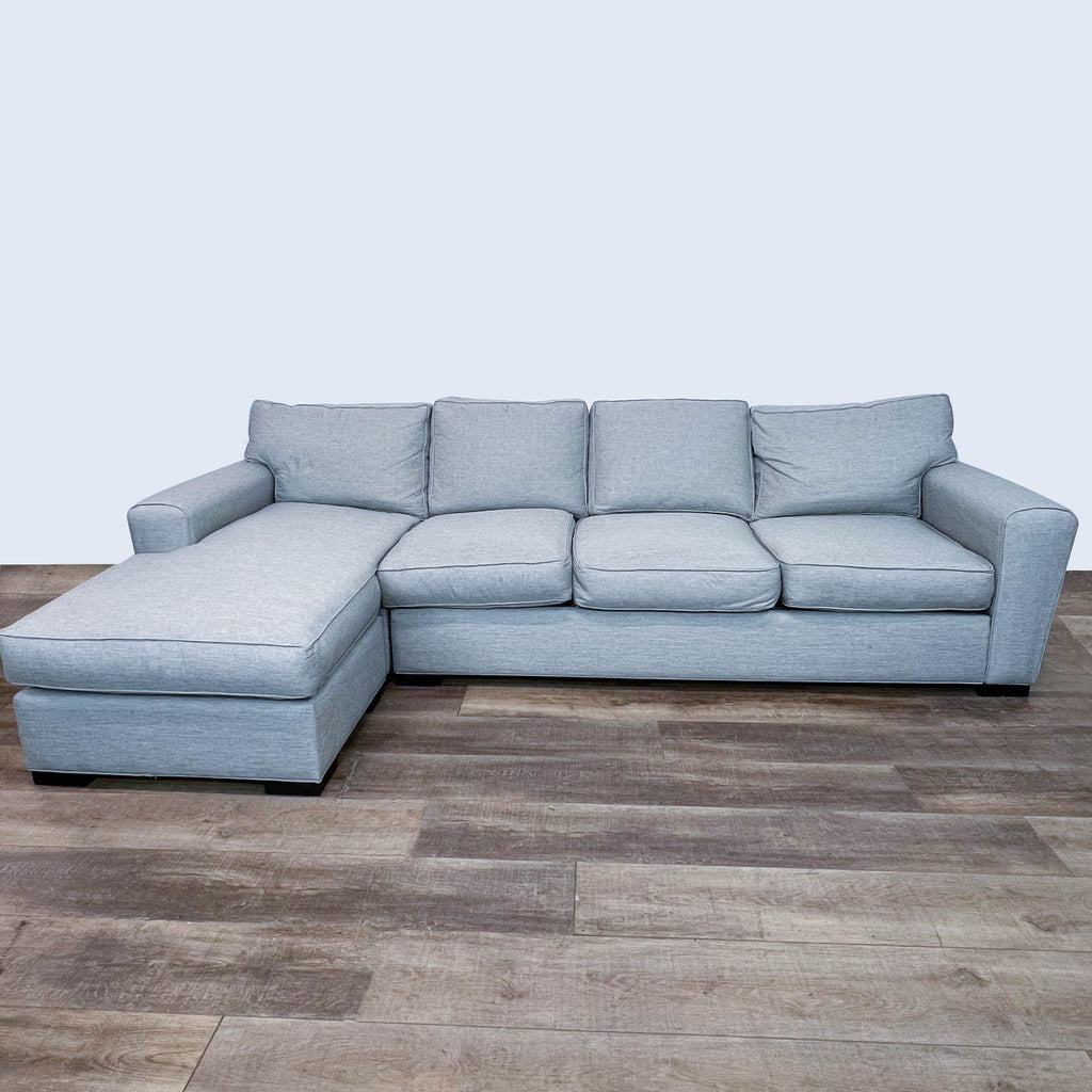 Stanton three-seater sectional sofa with a detachable chaise lounge, light gray fabric upholstery, on a wooden floor.