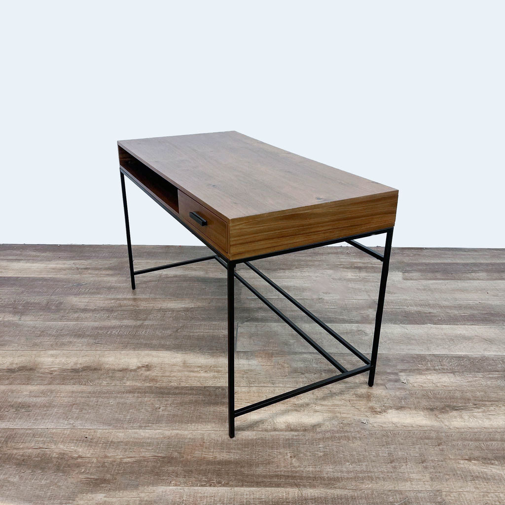 3. Side perspective of a contemporary wooden desk from Living Spaces with a drawer and sleek metal support structure.