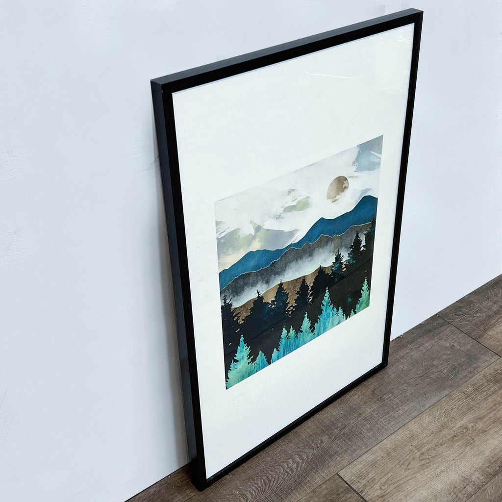 2. Angled view of a SpaceFrog artwork in a black frame featuring serene mountains, evergreen trees, and a moon on a light backdrop.