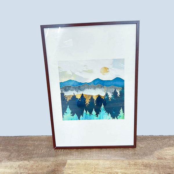 1. Framed artwork by SpaceFrog depicting a serene mountain landscape with trees and a moon, displayed against a wall.