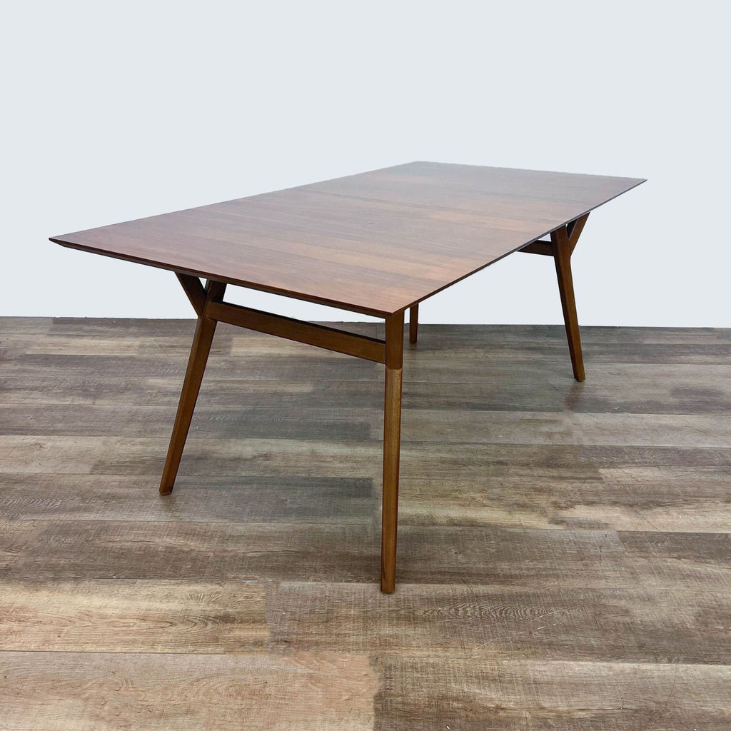 Expandable West Elm dining table with a drop-in leaf and classic design.