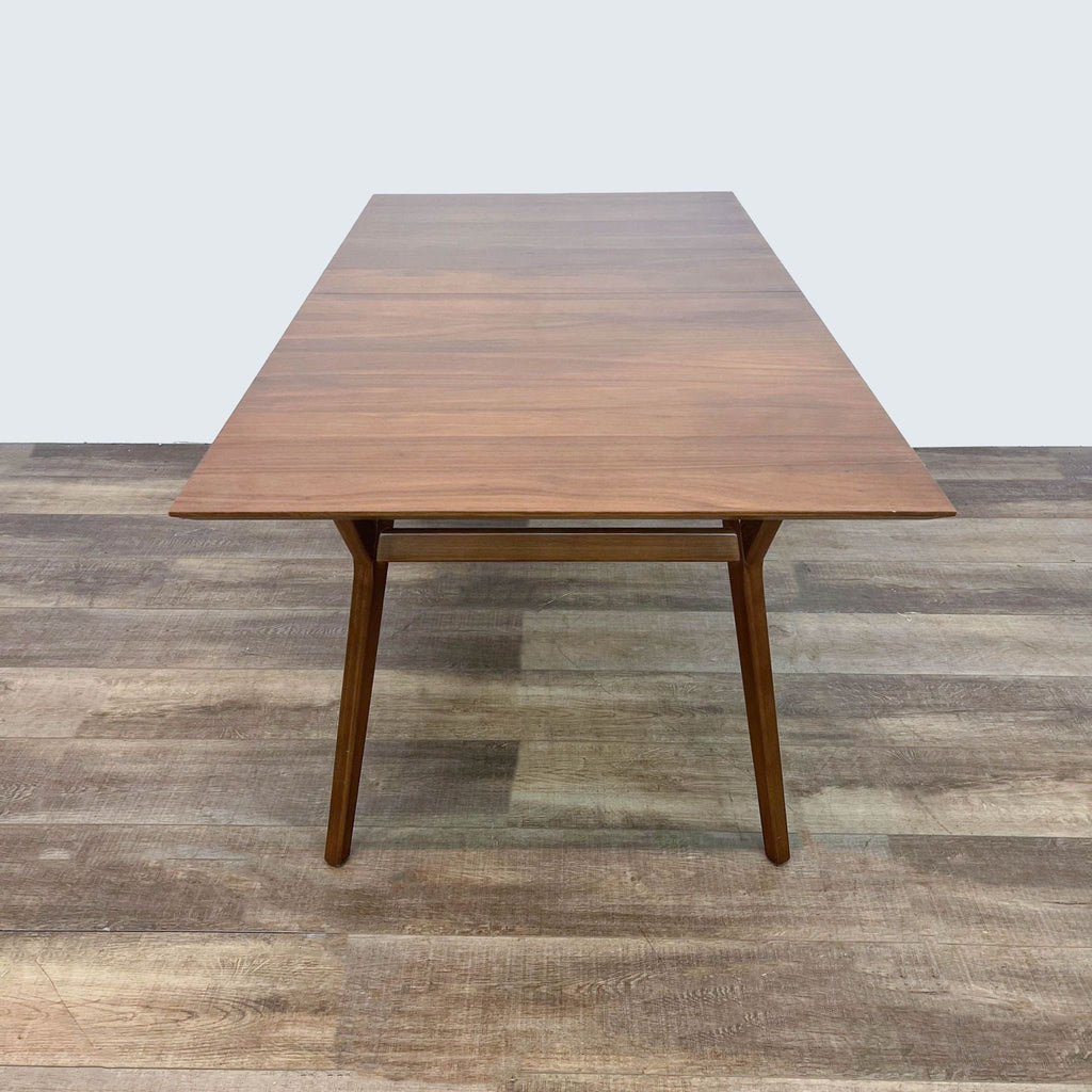 Sleek West Elm dining table featuring a rectangular top and sturdy legs.