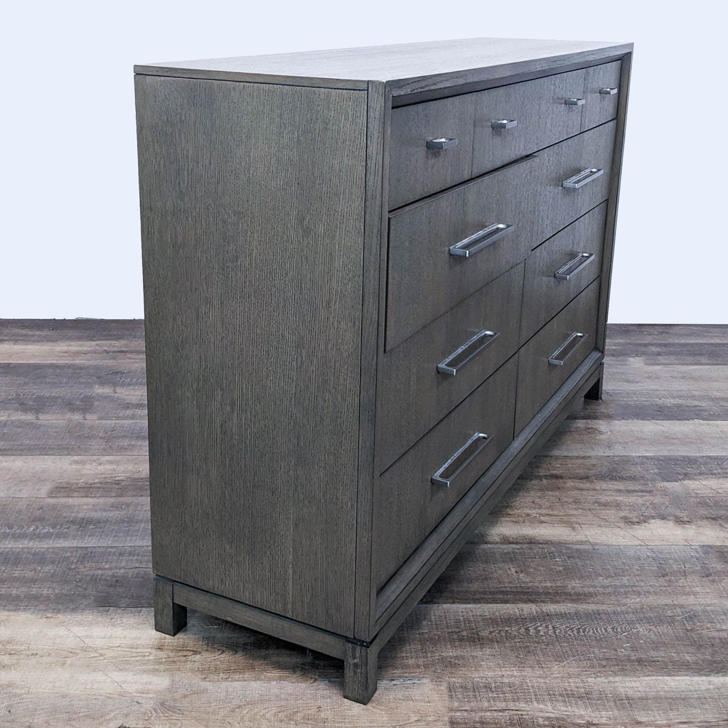 Angled view of the Highline Dresser by Rachael Ray Home in a Greige finish, displaying clean lines and modern design.