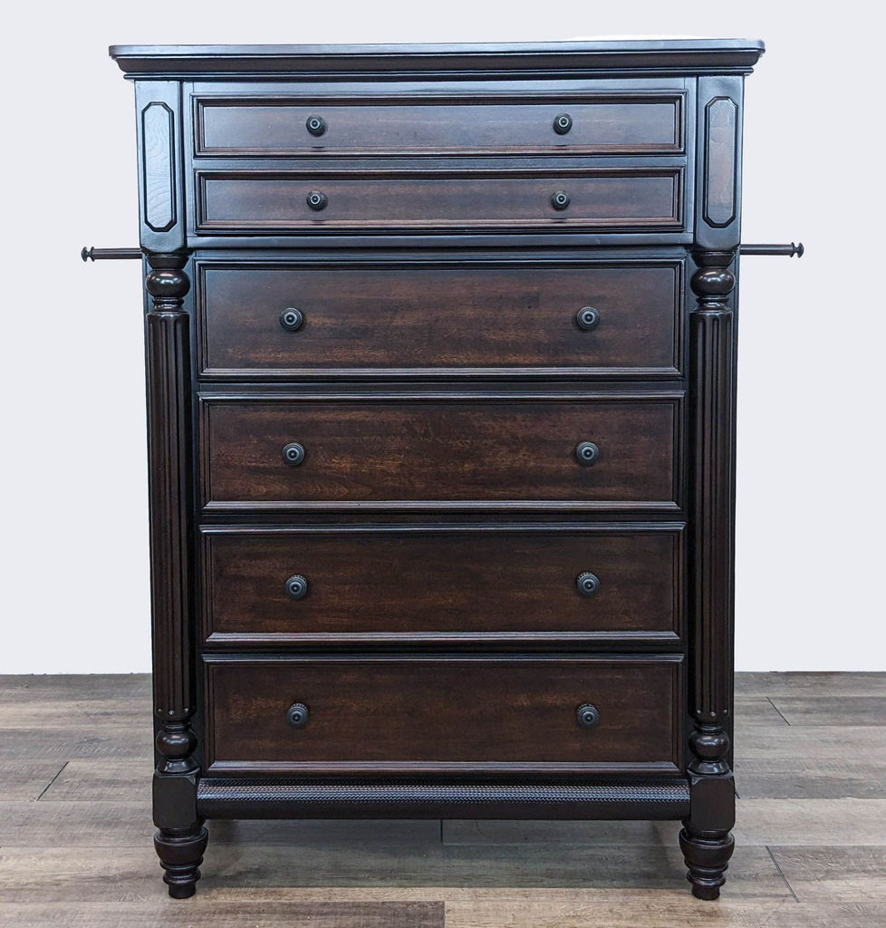 Frontal view of an Ashley Signature dresser with carved accents and dark finish, showcasing ornate hardware.