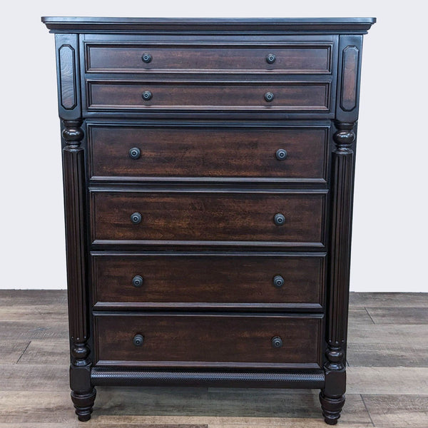 Ashley Signature dark brown wooden dresser with detailed trim and multiple drawers, on a wooden floor.