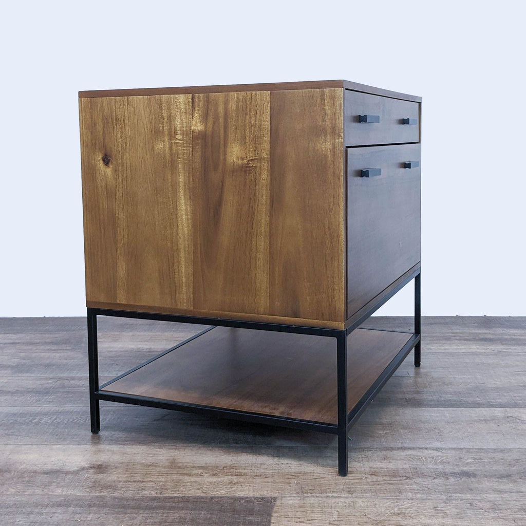 Angle view of Hollis engineered wood filing cabinet with sleek black steel support, closed drawers, brand Living Spaces.