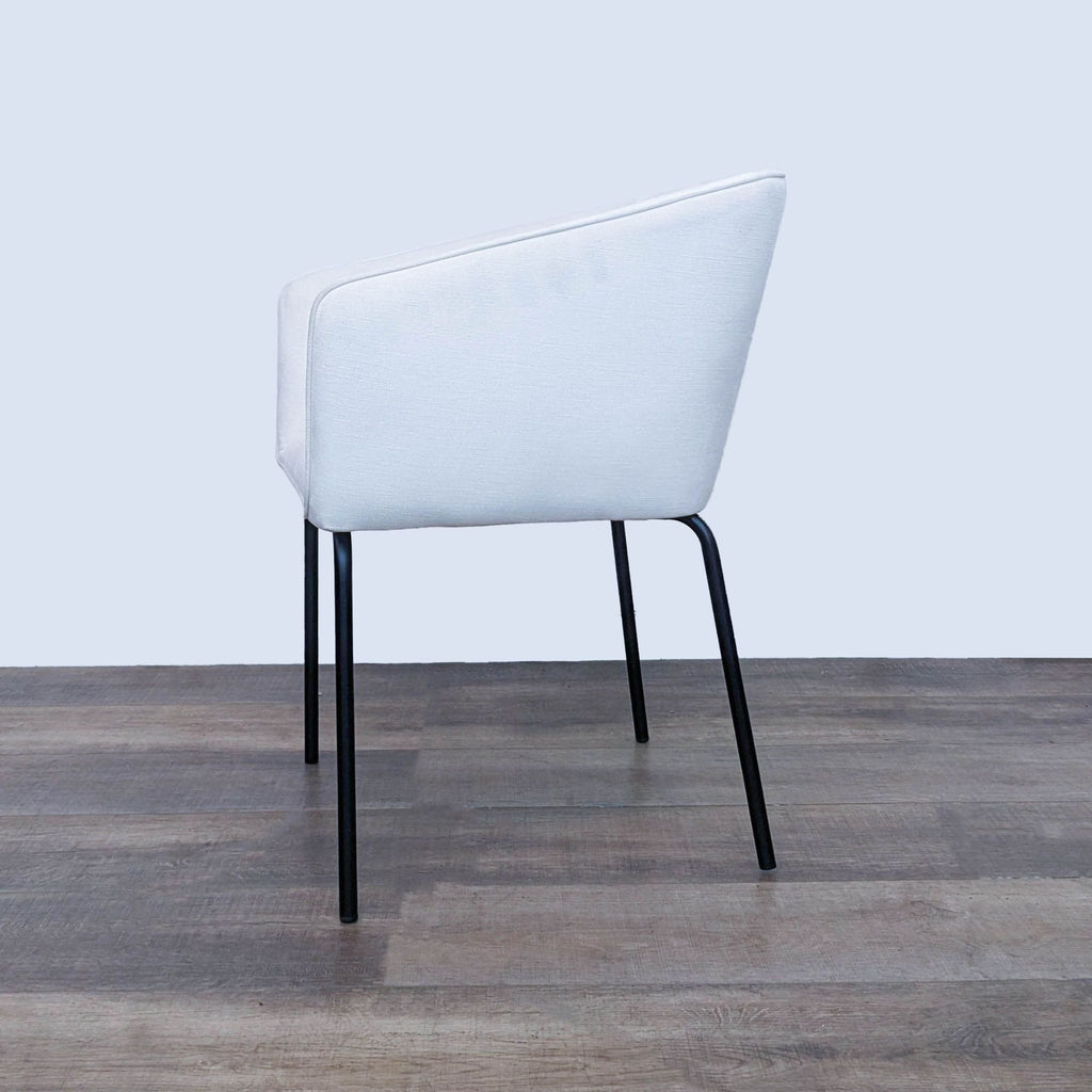 Angle view of the Mist White Avery Dining Chair from Diamond Sofa, displaying its contoured design and sleek black metal leg base.