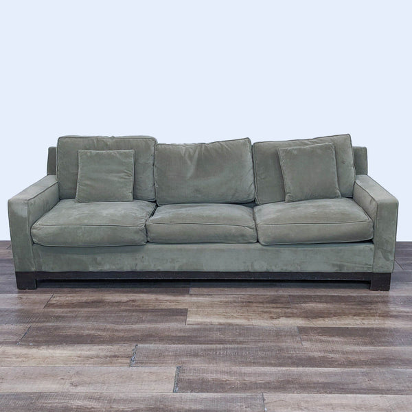 1. A Reperch 3-seater sleeper sofa in closed position with plush green cushions on a wooden floor.