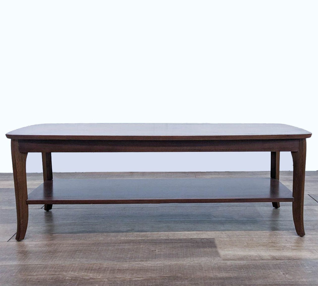 Reperch brand coffee table with a dark finish and lower shelf, on a wooden floor. 