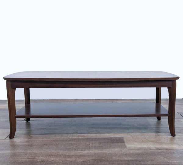 Reperch brand coffee table with a dark finish and lower shelf, on a wooden floor. 
