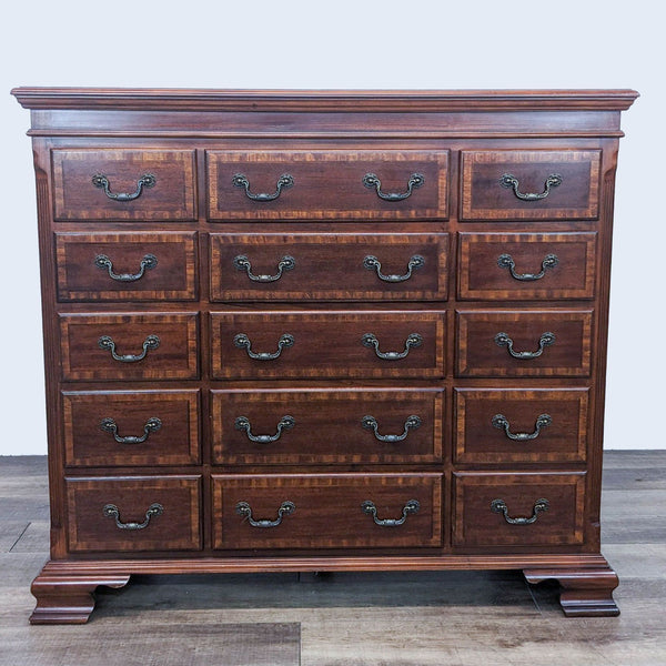 Reperch brand traditional wooden dresser with 15 drawers and metal drop handles, frontal view.