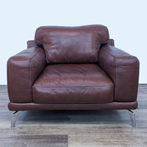 1. Scandinavian Designs Peruna lounge chair with plush cognac leather and angular chrome legs, viewed from the front.