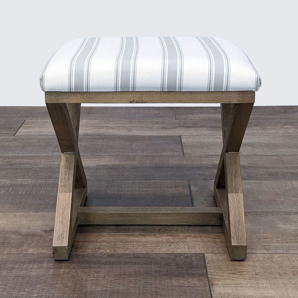 Reperch brand wooden ottoman with padded striped top and sturdy legs, showcased on a hardwood surface.