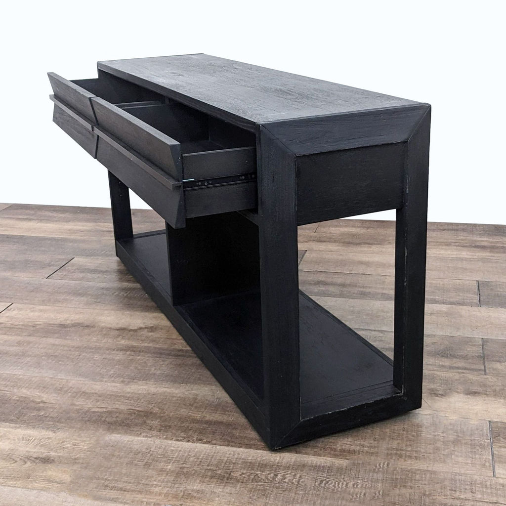 Living Spaces branded side table with drawers open to reveal storage, set on a wooden floor.