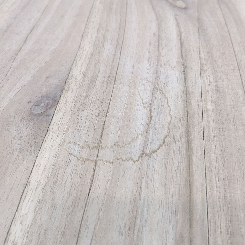Close-up of a water stain on the wooden surface of a Reperch side table.