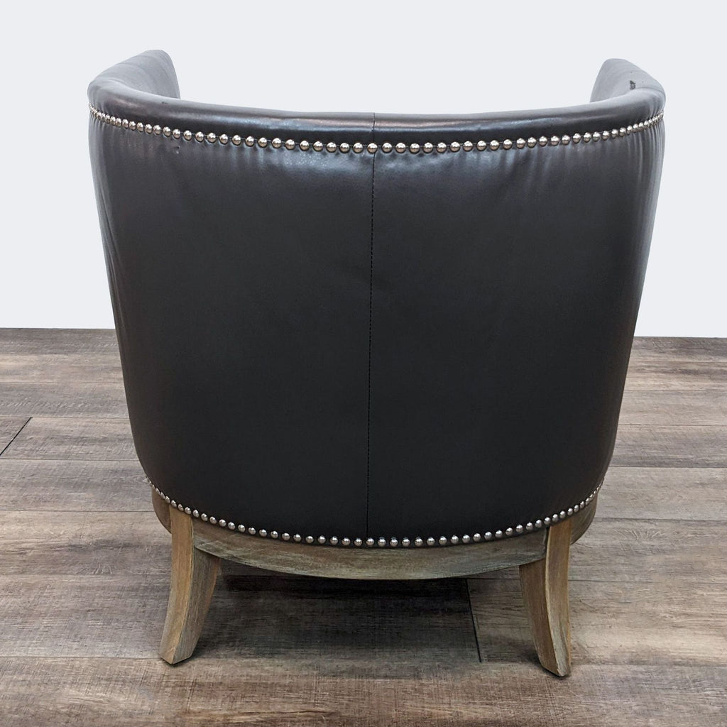 Rear view of a Jason Furniture leather chair showcasing the curved back and studs.