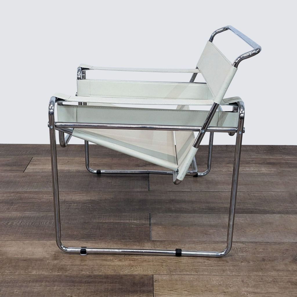Knoll Wassily chair with bicycle-inspired chrome frame and white leather seen at an angle on a wood floor.