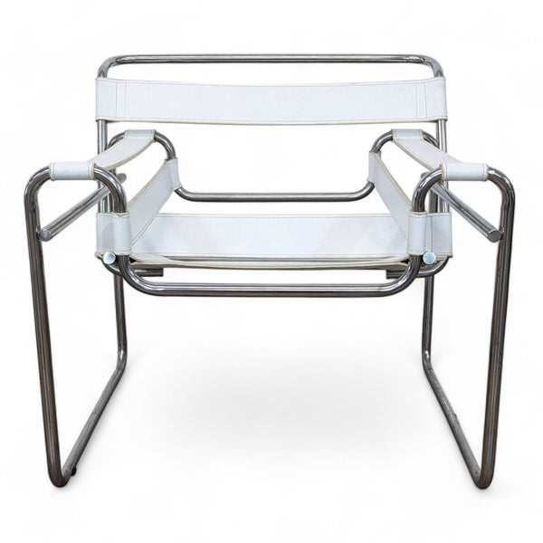 1. Front view of a Wassily club chair by Knoll with a chrome frame and white leather strapping on a white background.