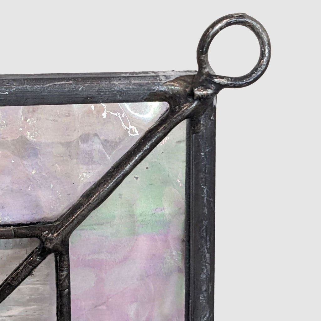 Detailed view of a hanging loop on a Reperch stained glass panel with iridescent glass and black solder.