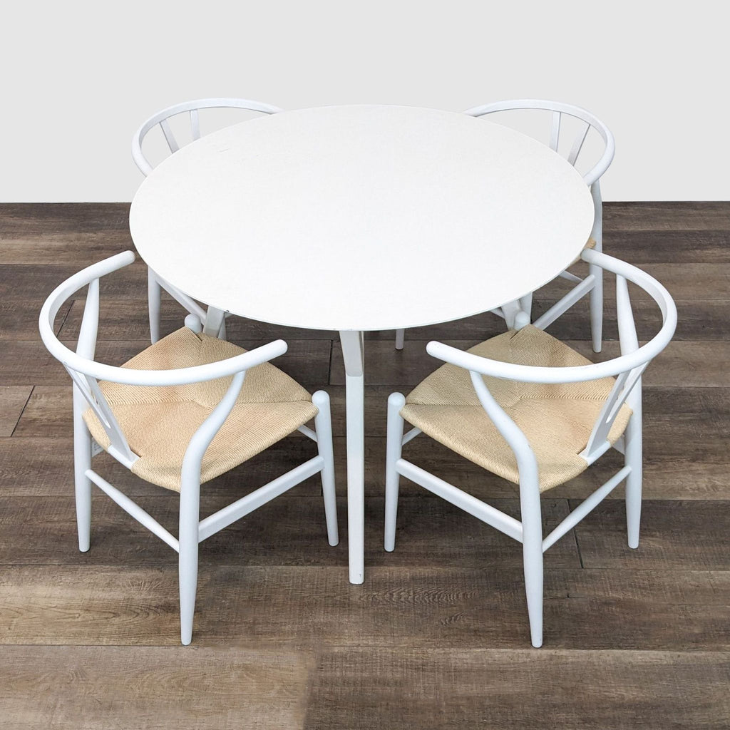 2. A white 5-piece dining set featuring a round table and four chairs with tan woven seats, displayed on a wooden floor.