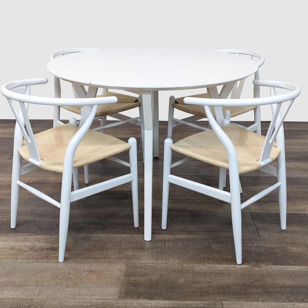 3. Mid-century modern dining set by West Elm and Birch Lane with a round table and four blue-framed chairs with natural seats.