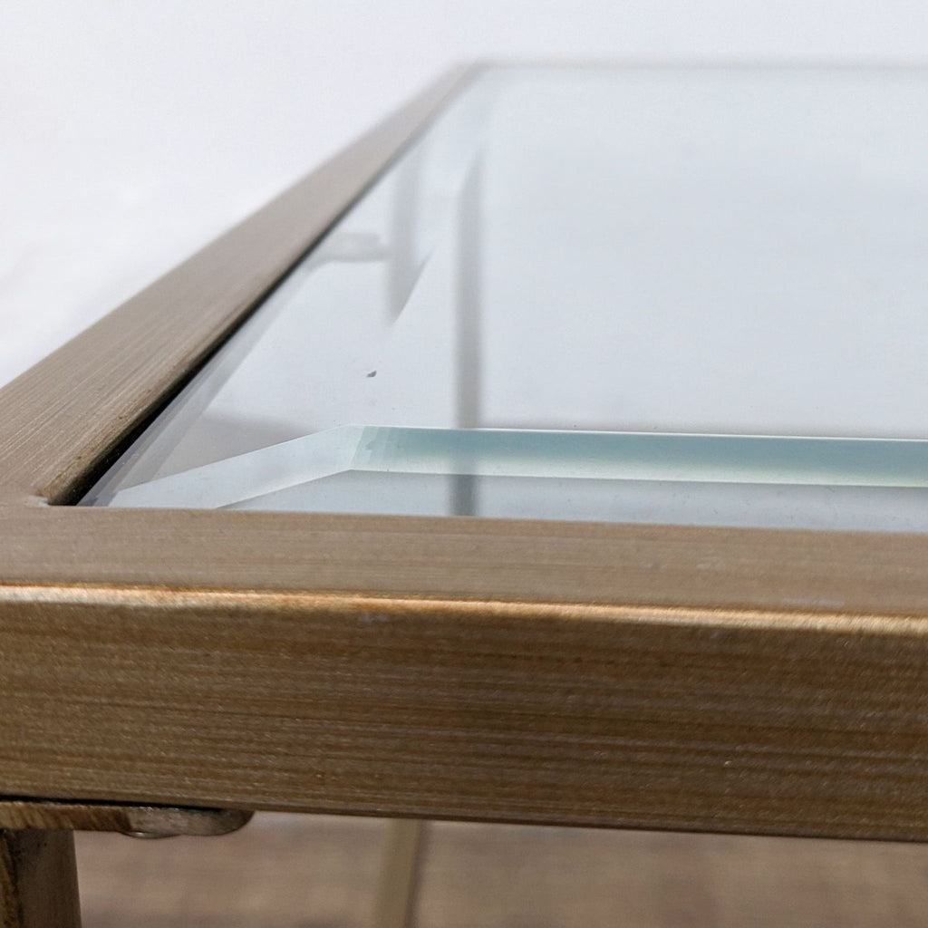 Close-up of Wayfair coffee table corner, showcasing metal frame and glass edge detail.