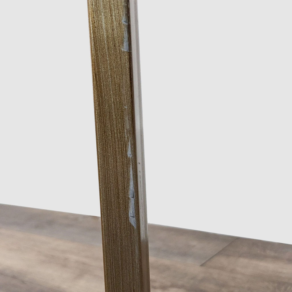 Detail view of the metal leg of a Wayfair coffee table with textured bronze finish.