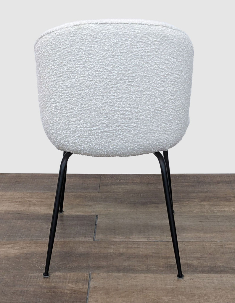 3. Back view of the Latese dining chair by Corrigan Studio showcasing the soft, textured boucle fabric and sleek metal legs.