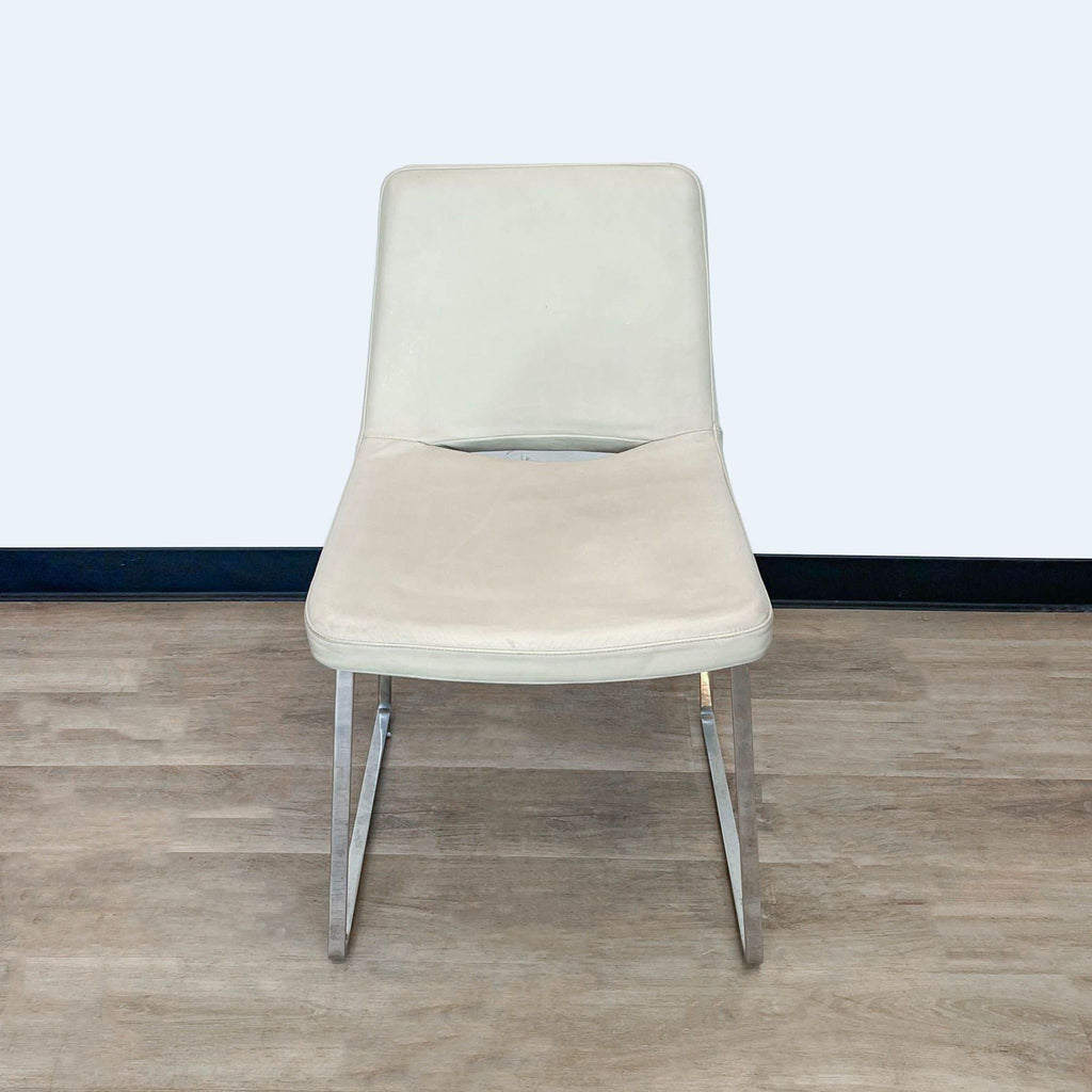 Modern Tui Lifestyle dining chair with beige upholstery and shiny chrome base, top view.