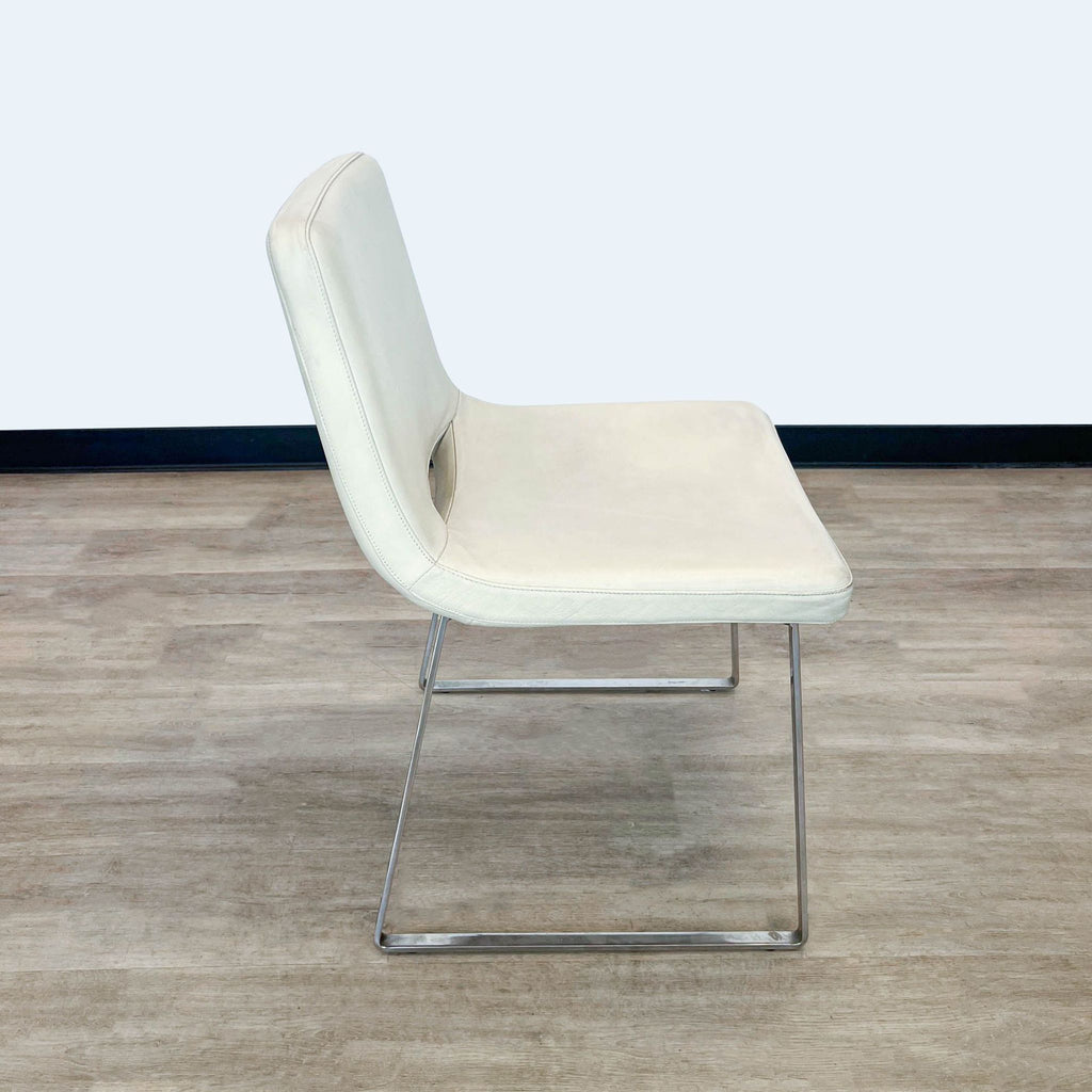 Tui Lifestyle dining chair in beige leather, angled view with chrome metal base.
