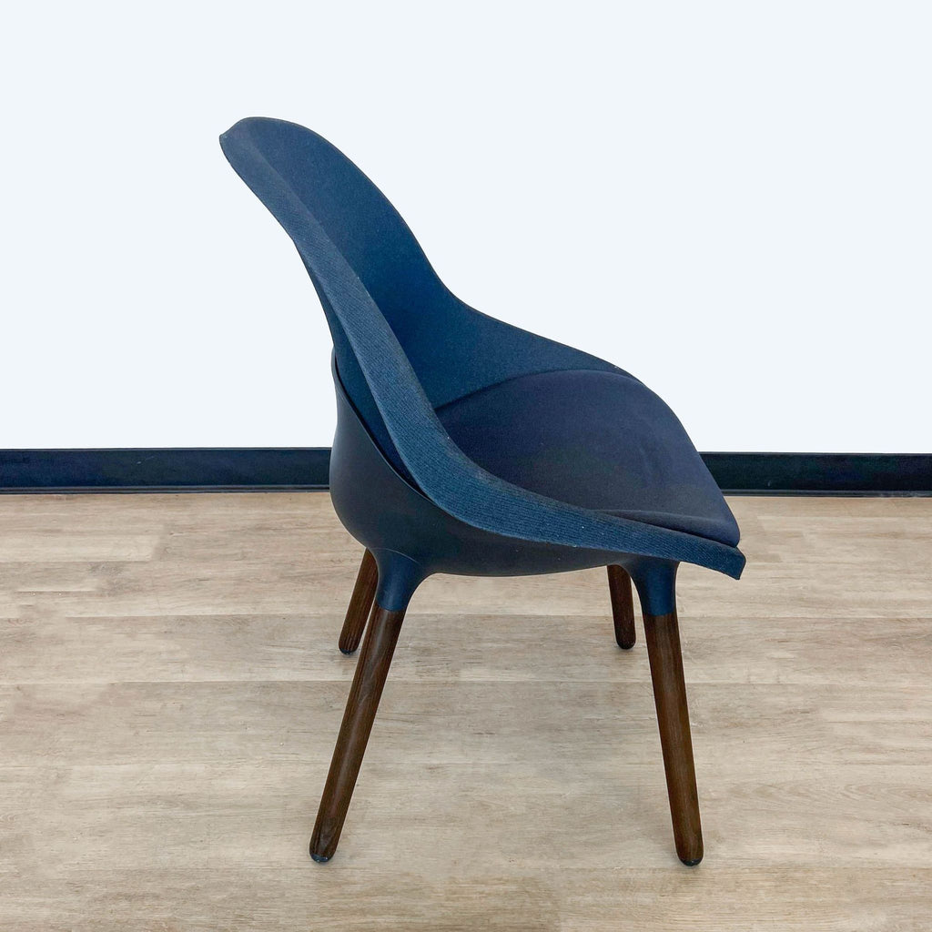 Side view of IKEA Baltsar chair highlighting its comfortable curve and sturdy wooden legs.